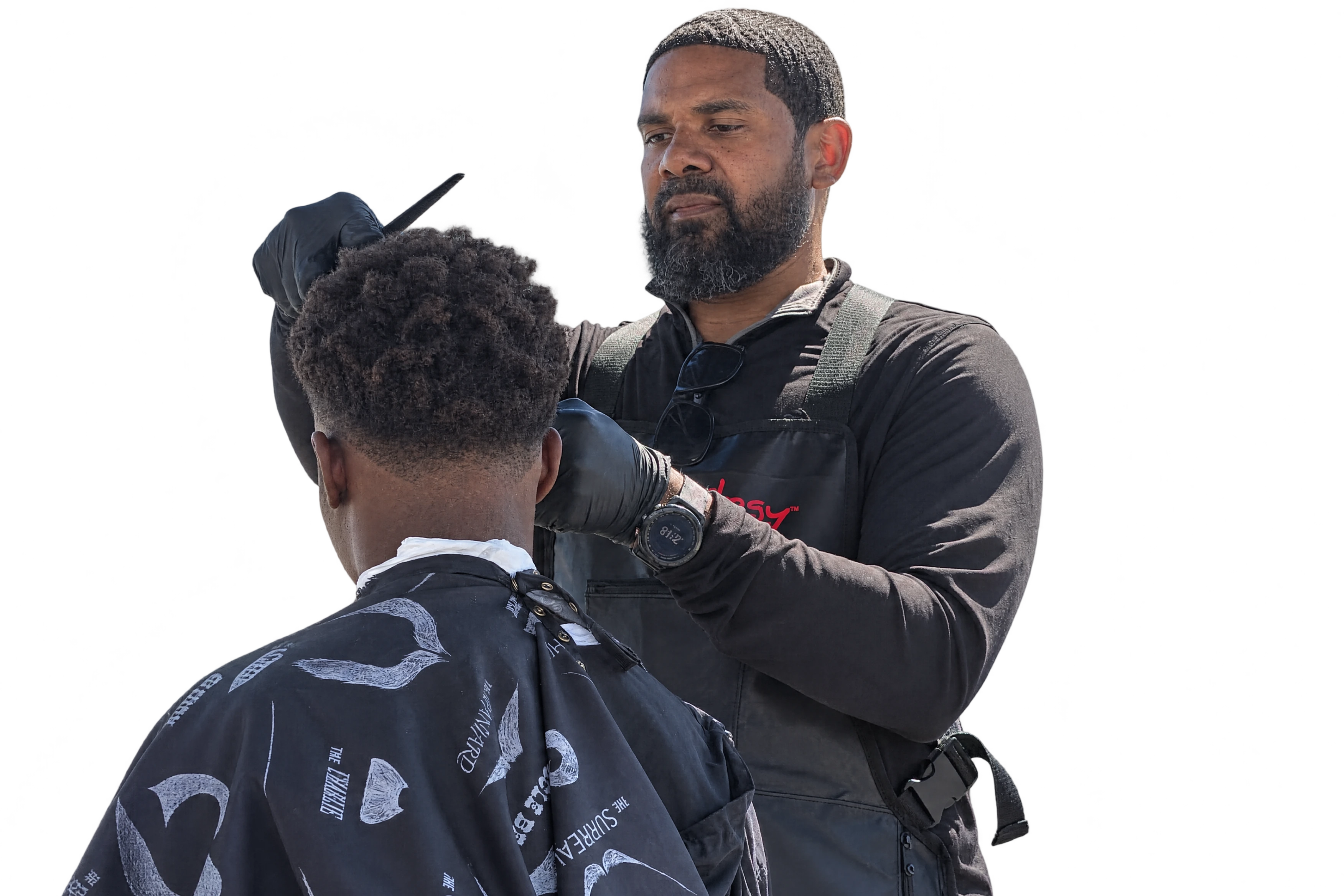 Kevin, owner and barber, cutting a client's hair